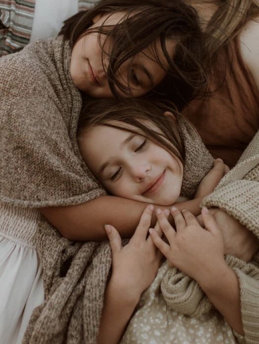 Natural family photography Melbourne. Sisters hugging each other